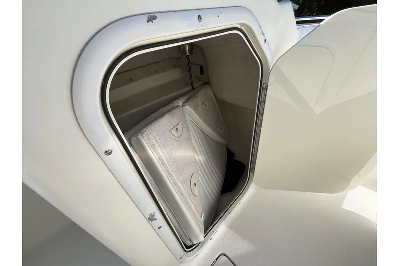Slide: The Image of Storage compartment on a 2006 Hydra-Sports Lightning 202 DC boat, featuring cushioned seating. - 23