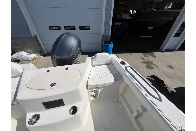 Slide: The Image of 2006 Hydra-Sports Lightning 202 DC boat interior with seating and engine view. - 26