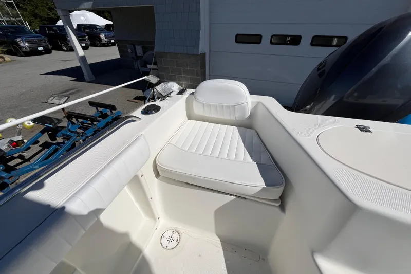 Slide: The Image of 2006 Hydra-Sports Lightning 202 DC boat interior with white seating and fishing rod holders. - 28