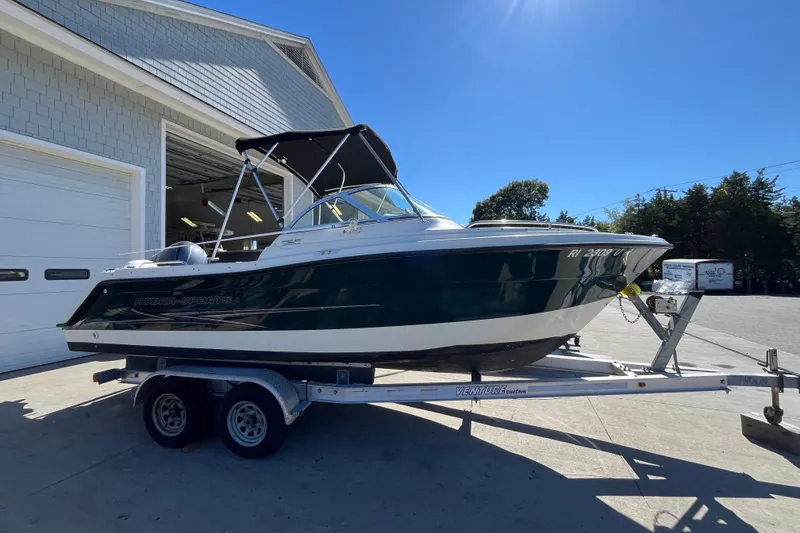 Slide: The Image of 2006 Hydra-Sports Lightning 202 DC boat on trailer, parked outside a garage. - 5