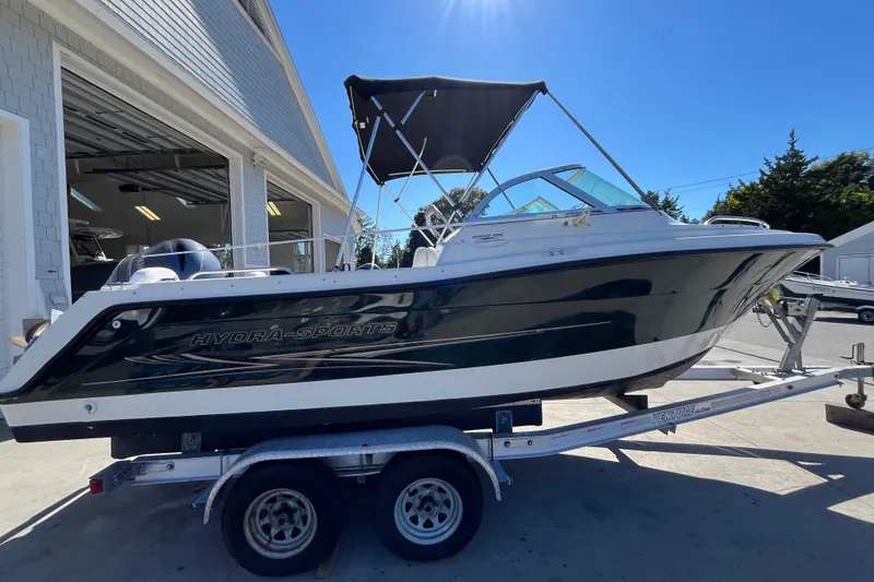 Slide: The Image of 2006 Hydra-Sports Lightning 202 DC boat on trailer, parked outside a garage. - 6
