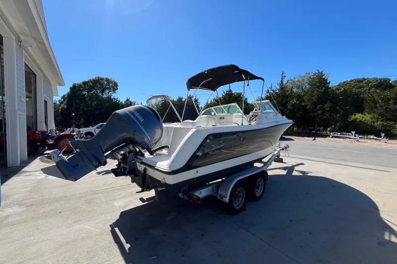 Slide: The Image of 2006 Hydra-Sports Lightning 202 DC boat on trailer, parked outdoors under clear blue sky. - 7