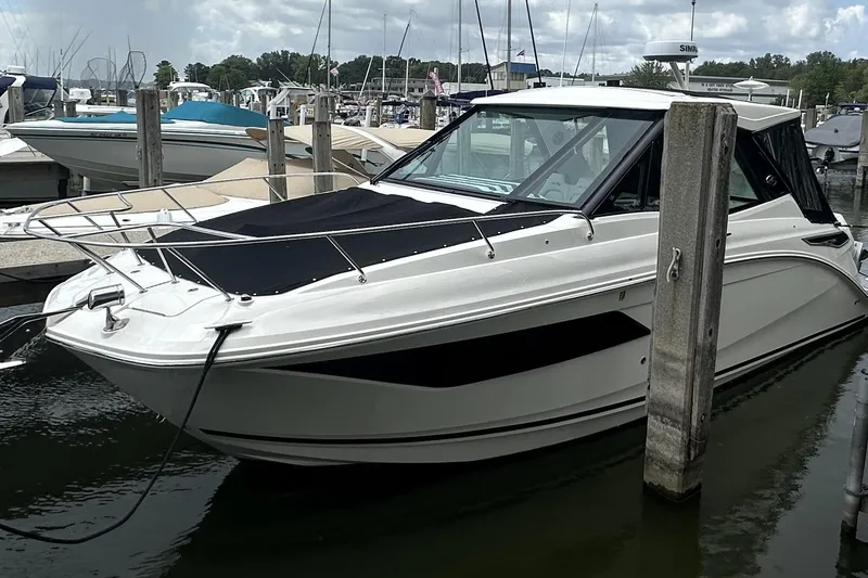 The Image of 2021 Sea Ray Sundancer 320 Coupe Outboard docked at marina, sleek design, white exterior. - 0