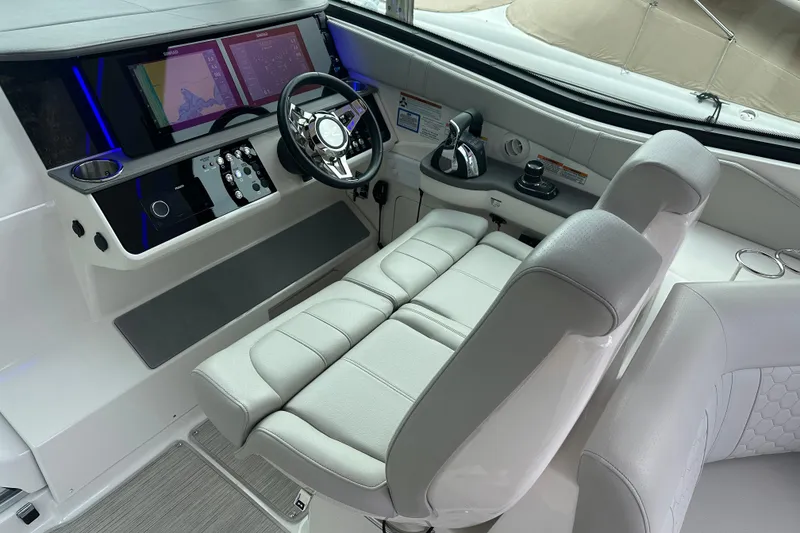 Slide: The Image of 2021 Sea Ray Sundancer 320 Coupe Outboard helm with modern controls and dual screens. - 10