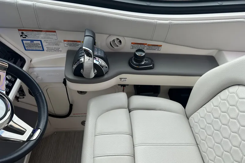 Slide: The Image of 2021 Sea Ray Sundancer 320 Coupe Outboard helm with controls and steering wheel. - 12