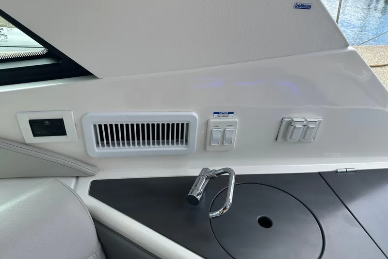 Slide: The Image of 2021 Sea Ray Sundancer 320 Coupe Outboard interior with sink and control panel. - 13