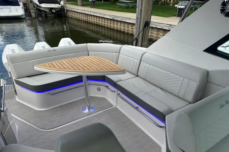 Slide: The Image of Luxurious seating area on 2021 Sea Ray Sundancer 320 Coupe Outboard with elegant wooden table. - 17