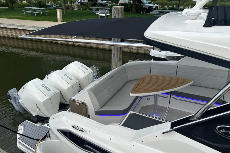 Slide: The Image of 2021 Sea Ray Sundancer 320 Coupe Outboard with triple Mercury engines docked. - 22