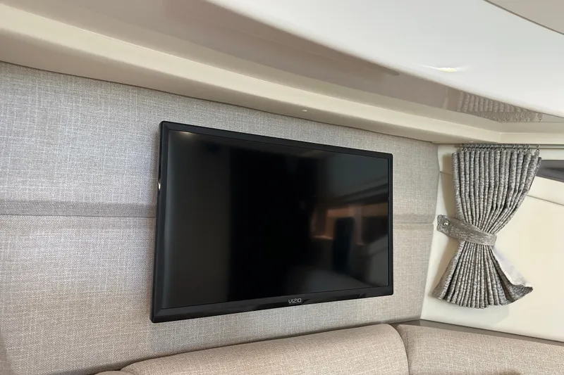 Slide: The Image of Flat-screen TV in 2021 Sea Ray Sundancer 320 Coupe Outboard cabin, with elegant curtains. - 27