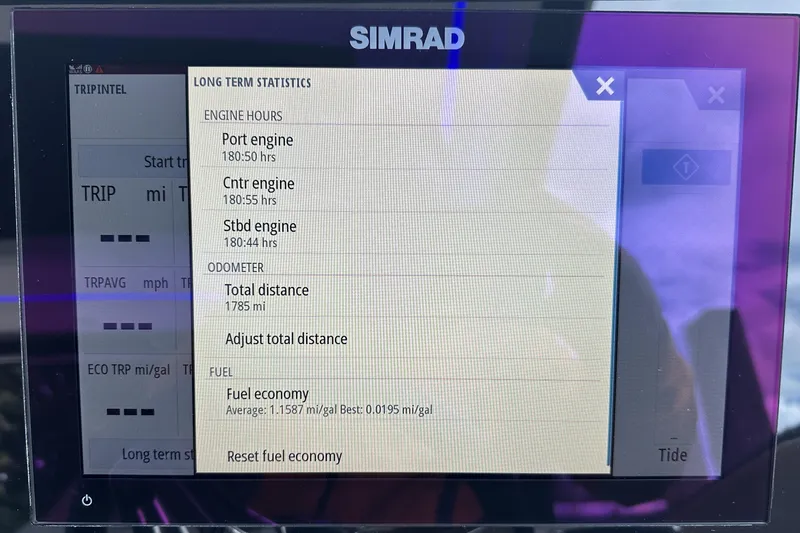 Slide: The Image of Simrad display showing engine hours and fuel economy for 2021 Sea Ray Sundancer 320 Coupe Outboard. - 31