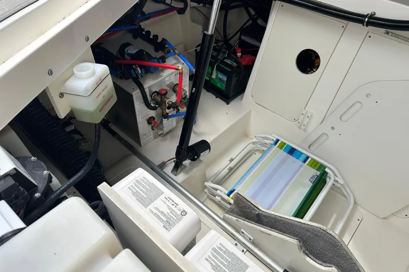 Slide: The Image of 2021 Sea Ray Sundancer 320 Coupe Outboard engine compartment with equipment and storage. - 37