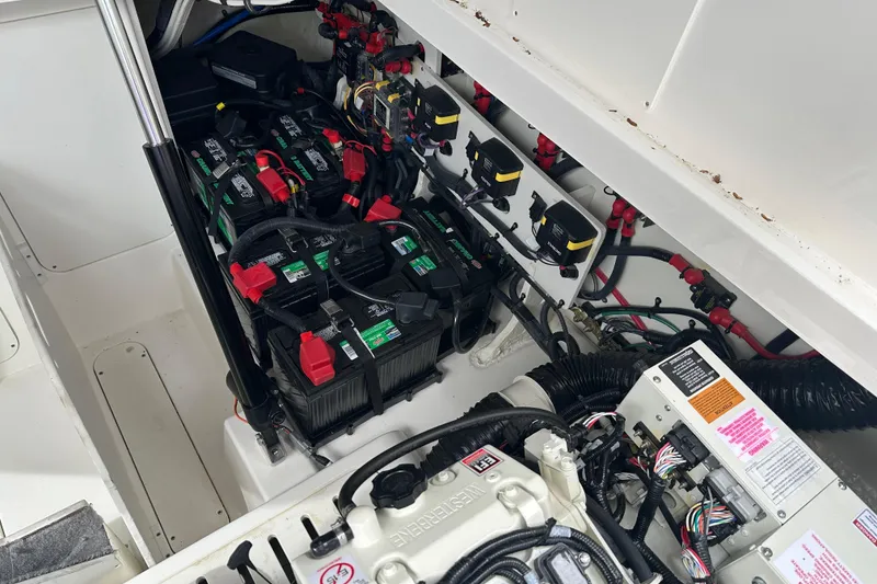 Slide: The Image of Engine compartment of 2021 Sea Ray Sundancer 320 Coupe Outboard with batteries and wiring. - 38