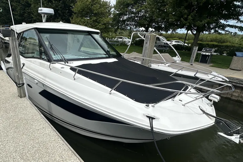 Slide: The Image of 2021 Sea Ray Sundancer 320 Coupe Outboard docked at marina. - 4