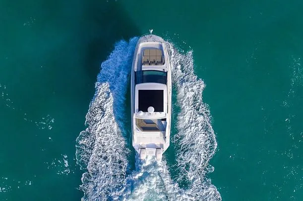 Slide: The Image of Manufacturer Provided Image: Aerial view of 2021 Sea Ray Sundancer 320 Coupe OB cruising on turquoise water. - 44