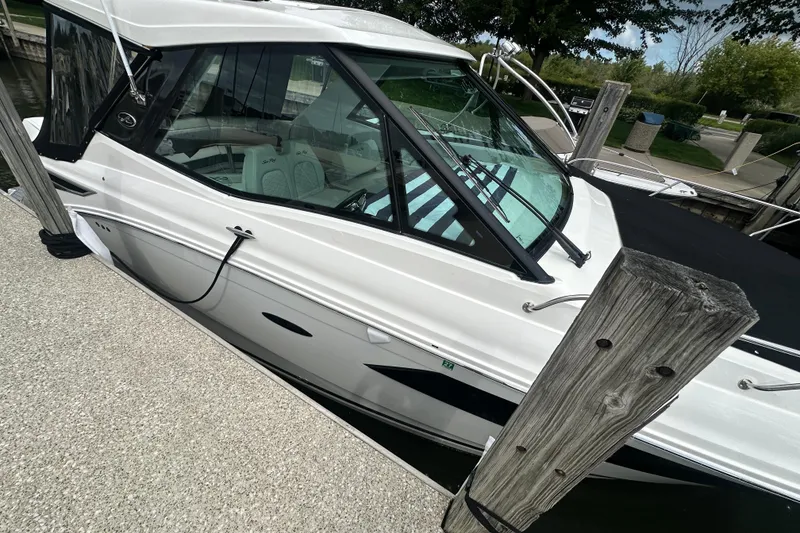 Slide: The Image of 2021 Sea Ray Sundancer 320 Coupe Outboard docked, showcasing sleek design and modern features. - 5