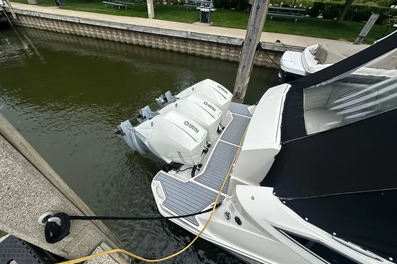 Slide: The Image of 2021 Sea Ray Sundancer 320 Coupe Outboard docked with triple engines. - 7