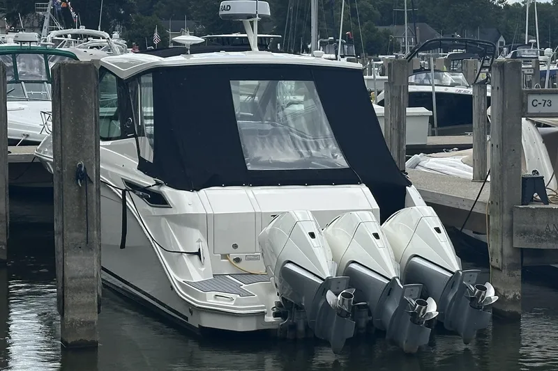 Slide: The Image of 2021 Sea Ray Sundancer 320 Coupe Outboard docked with triple engines, covered cabin. - 8