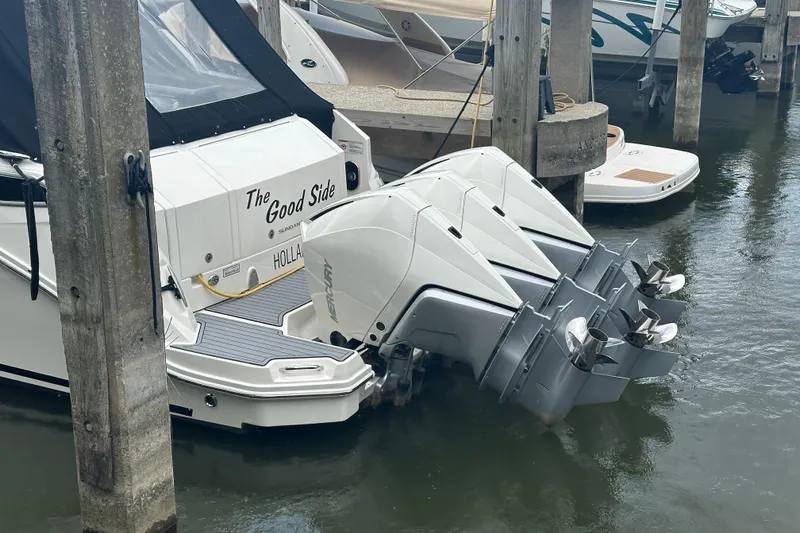 Slide: The Image of 2021 Sea Ray Sundancer 320 Coupe Outboard docked with triple Mercury engines. - 9