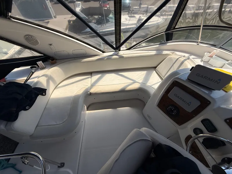 Slide: The Image of 2002 Bayliner 3488 Motoryacht interior with seating and Garmin navigation system. - 13