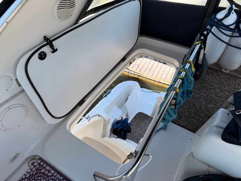 Slide: The Image of 2002 Bayliner 3488 Motoryacht interior with open hatch and dock view. - 19