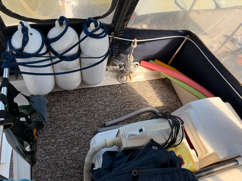 Slide: The Image of 2002 Bayliner 3488 Motoryacht interior with fenders, pool noodles, and vacuum cleaner. - 28