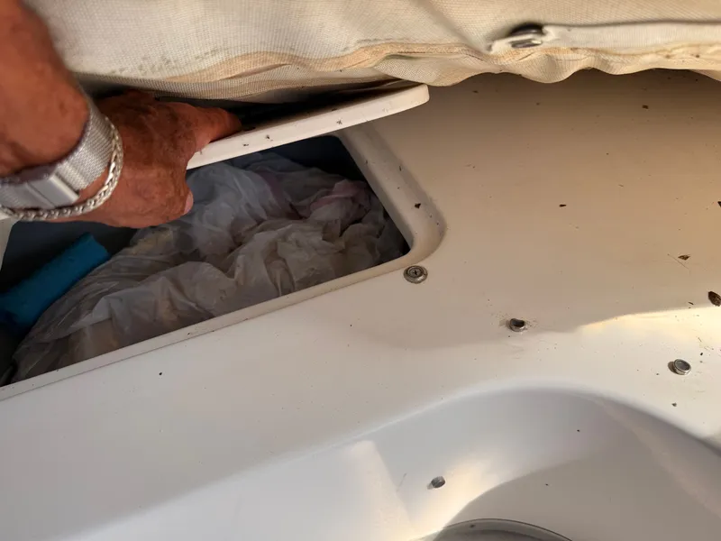 Slide: The Image of Hand accessing storage compartment on 2002 Bayliner 3488 Motoryacht. - 30