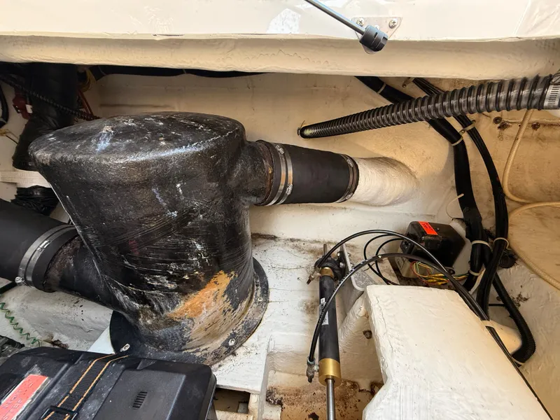 Slide: The Image of Engine compartment of a 2002 Bayliner 3488 Motoryacht, showing exhaust and mechanical components. - 43
