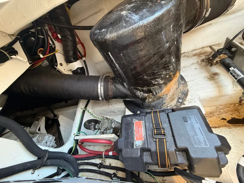 Slide: The Image of Engine compartment of a 2002 Bayliner 3488 Motoryacht, showing various mechanical components and wiring. - 45