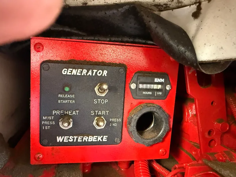 Slide: The Image of Westerbeke generator control panel on 2002 Bayliner 3488 Motoryacht, showing operational switches and hour meter. - 46