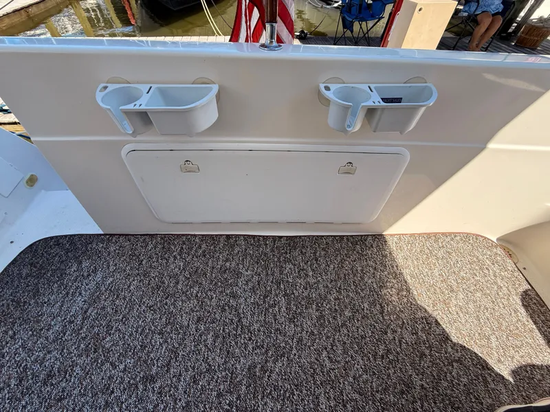 Slide: The Image of 2002 Bayliner 3488 Motoryacht deck with cup holders and storage compartment. - 48