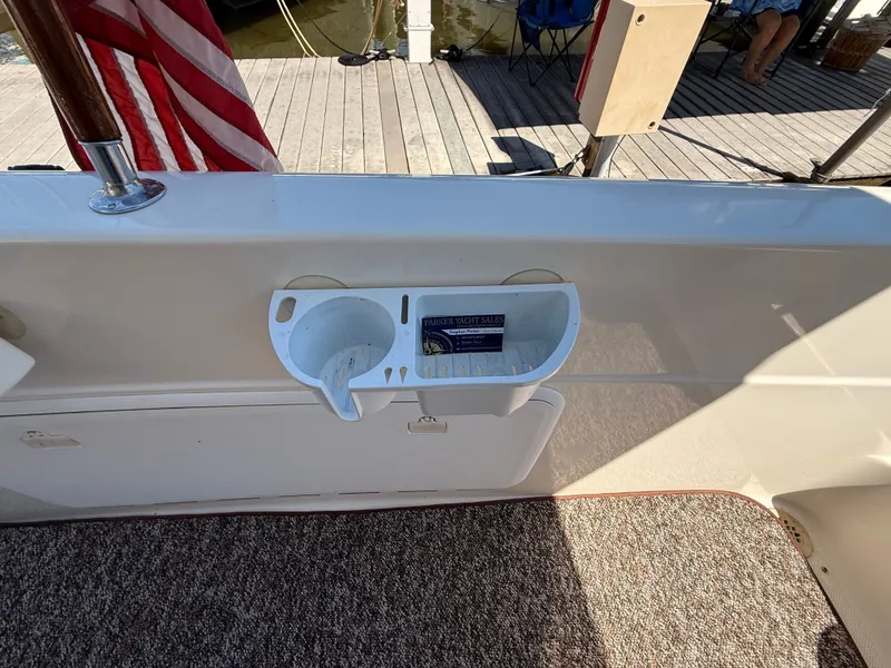 Slide: The Image of 2002 Bayliner 3488 Motoryacht deck with American flag and cup holder. - 49