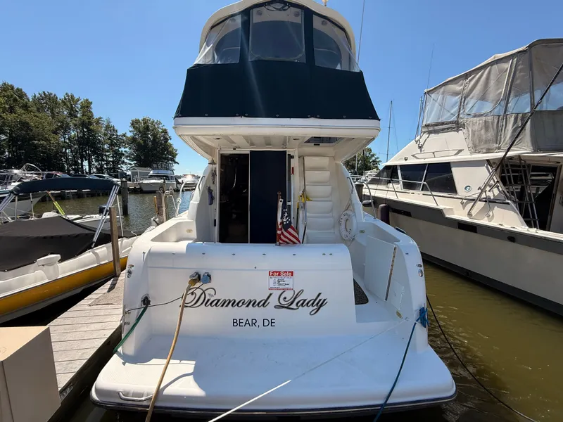 Slide: The Image of 2002 Bayliner 3488 Motoryacht "Diamond Lady" docked, rear view with American flag. - 5