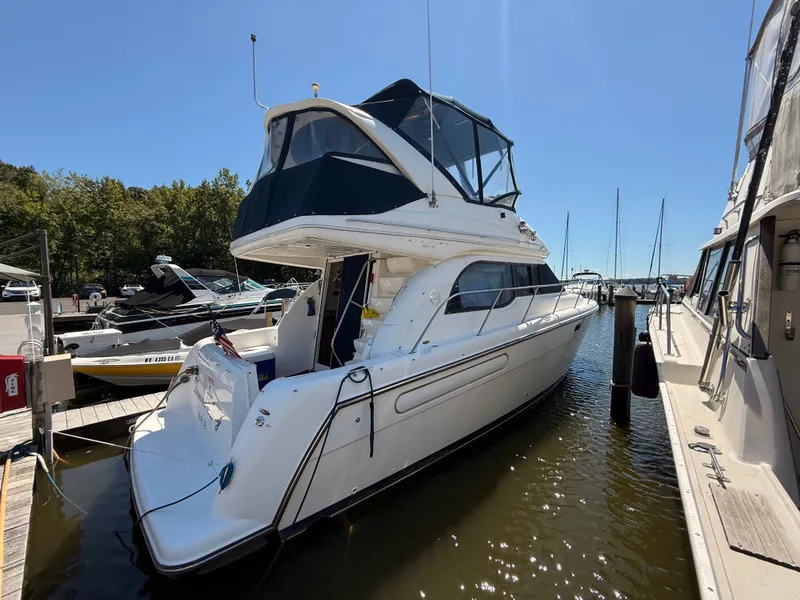Slide: The Image of 2002 Bayliner 3488 Motoryacht docked at marina under clear blue sky. - 6