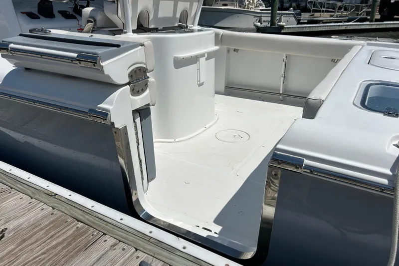 Slide: The Image of 2021 Sea Hunt Gamefish 25 boat interior, featuring sleek white seating and stainless steel accents. - 10