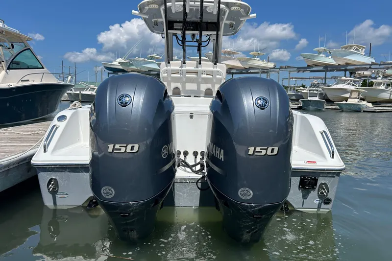 Slide: The Image of 2021 Sea Hunt Gamefish 25 with dual Yamaha 150 engines docked at marina. - 11