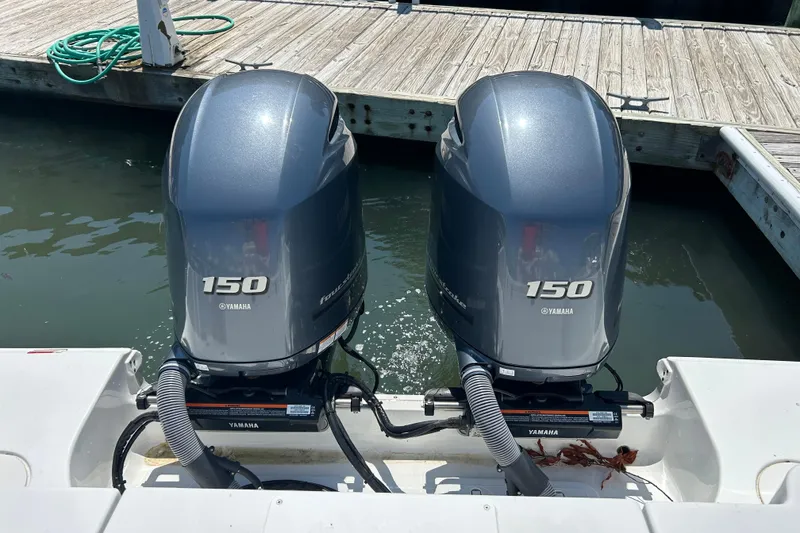 Slide: The Image of Twin Yamaha 150 engines on a 2021 Sea Hunt Gamefish 25 boat at dock. - 12