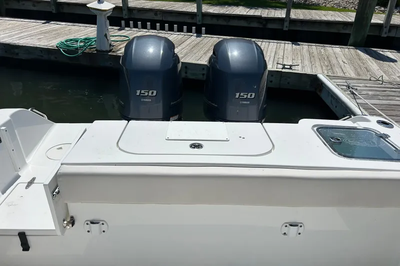 Slide: The Image of 2021 Sea Hunt Gamefish 25 with twin Yamaha 150 engines at dock. - 13