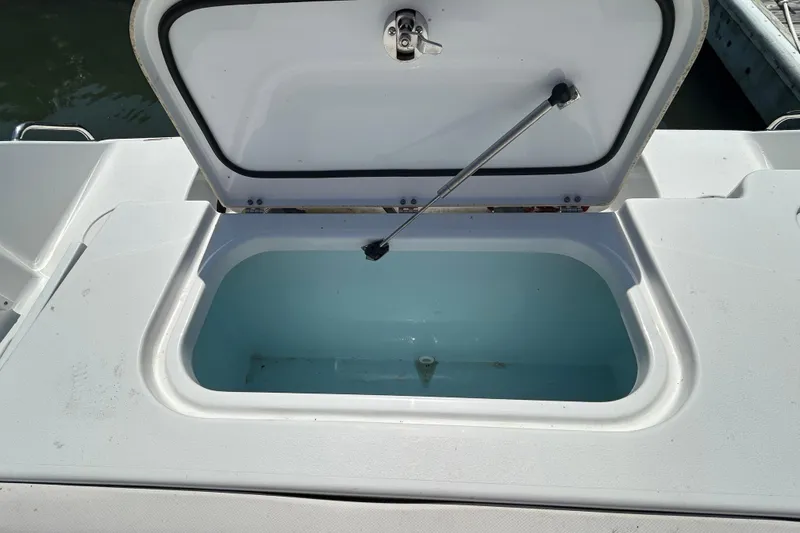 Slide: The Image of Open storage compartment on 2021 Sea Hunt Gamefish 25 boat, showing interior. - 14