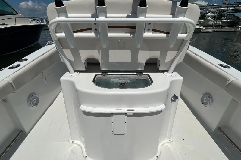 Slide: The Image of 2021 Sea Hunt Gamefish 25 boat interior with fishing rod holders and livewell. - 16