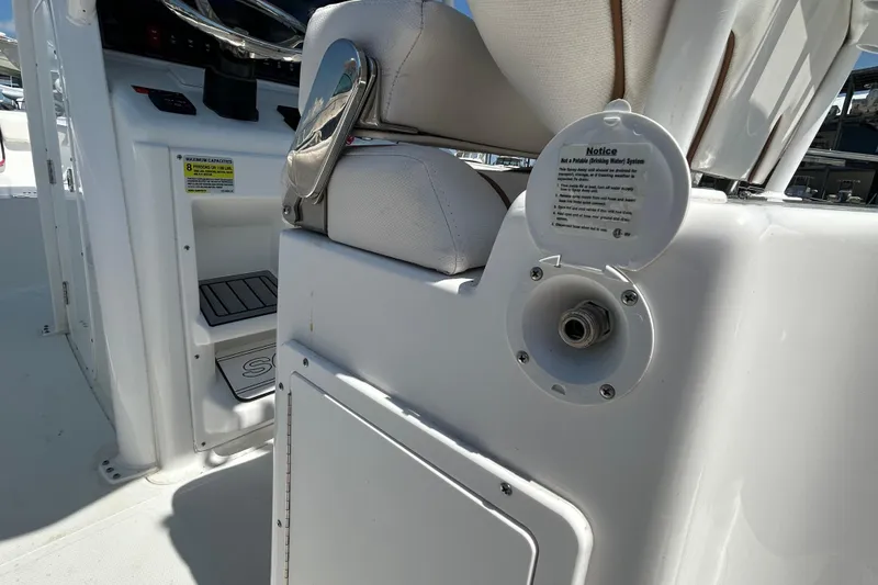 Slide: The Image of 2021 Sea Hunt Gamefish 25 boat interior, showing seating and non-potable water system notice. - 18