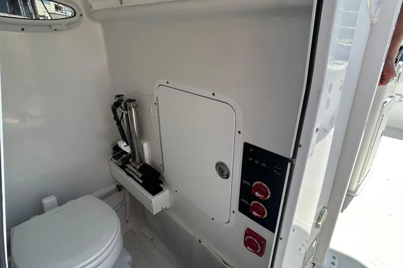 Slide: The Image of 2021 Sea Hunt Gamefish 25 interior with toilet and control panel. - 19