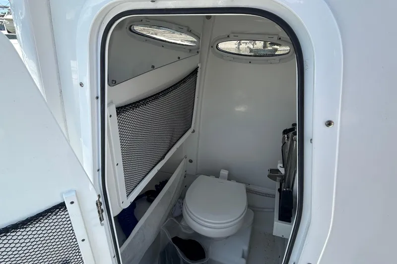 Slide: The Image of Interior view of 2021 Sea Hunt Gamefish 25 boat's compact bathroom with toilet. - 20
