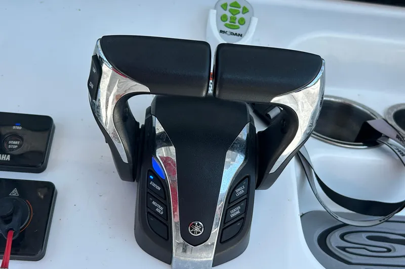 Slide: The Image of Throttle controls on a 2021 Sea Hunt Gamefish 25 boat dashboard. - 25