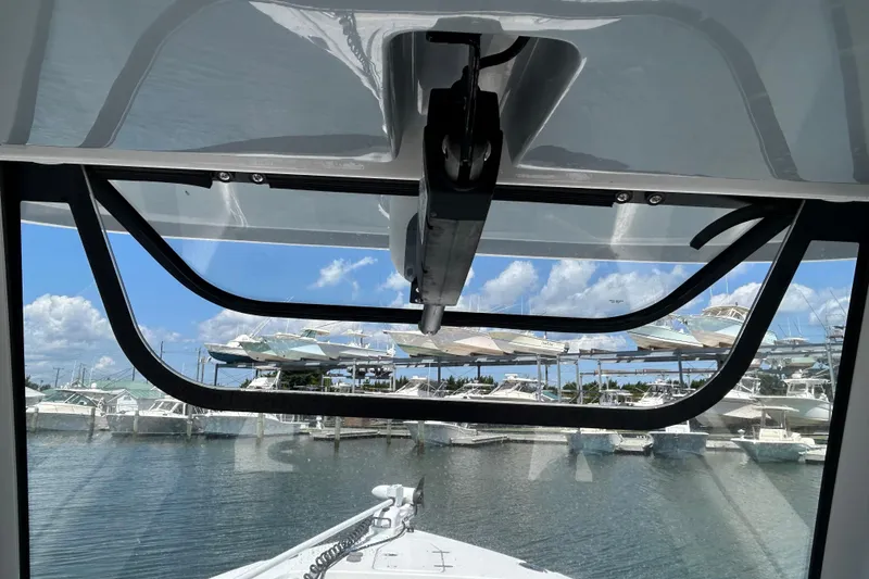 Slide: The Image of 2021 Sea Hunt Gamefish 25 boat view from cabin, overlooking marina with docked boats. - 29