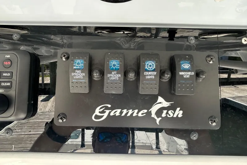 Slide: The Image of Control panel of a 2021 Sea Hunt Gamefish 25 boat with labeled switches. - 31