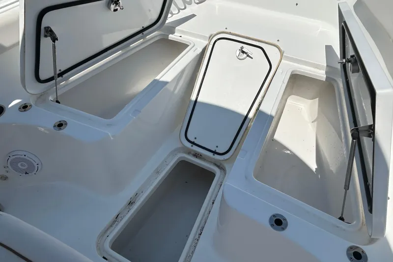 Slide: The Image of 2021 Sea Hunt Gamefish 25 boat storage compartments open, showcasing spacious interior. - 37