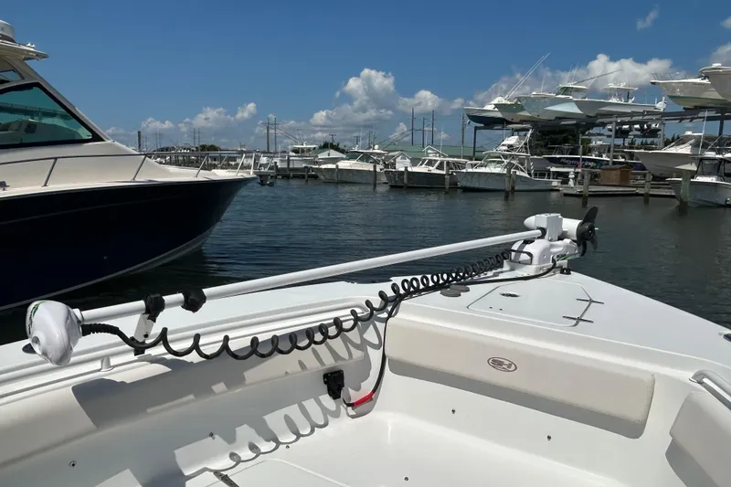Slide: The Image of 2021 Sea Hunt Gamefish 25 boat docked at marina under clear blue sky. - 38