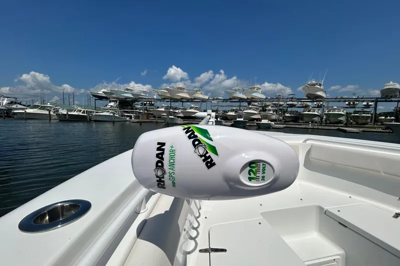 Slide: The Image of 2021 Sea Hunt Gamefish 25 with Rhodan GPS Anchor, docked at marina under blue sky. - 39