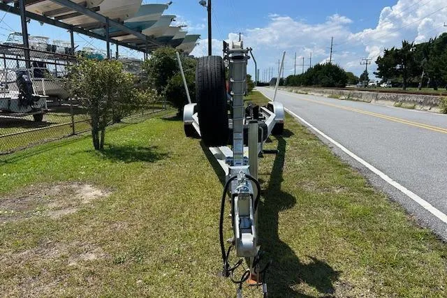 Slide: The Image of Trailer for 2021 Sea Hunt Gamefish 25 parked on roadside grass. - 47