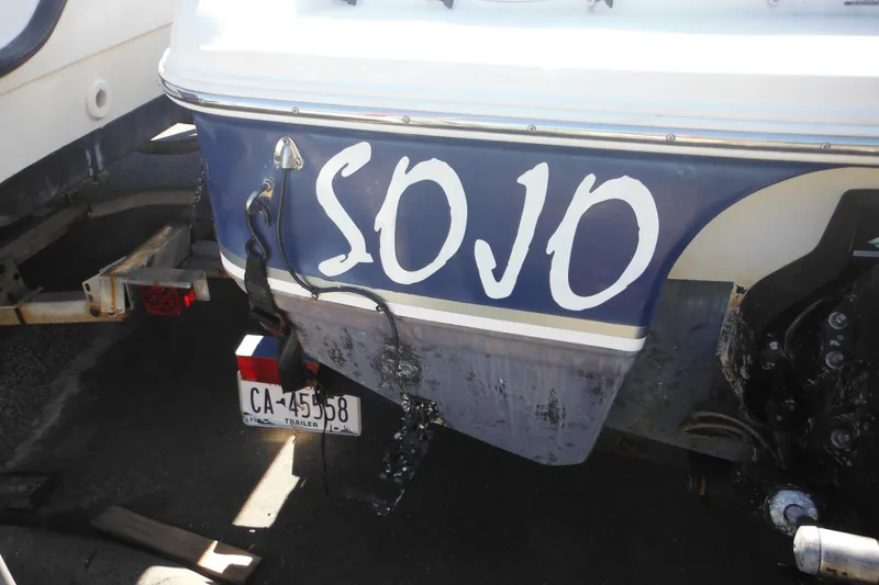 Slide: The Image of 2003 Chaparral 180 SS boat with "SOJO" name, trailer license plate visible. - 11